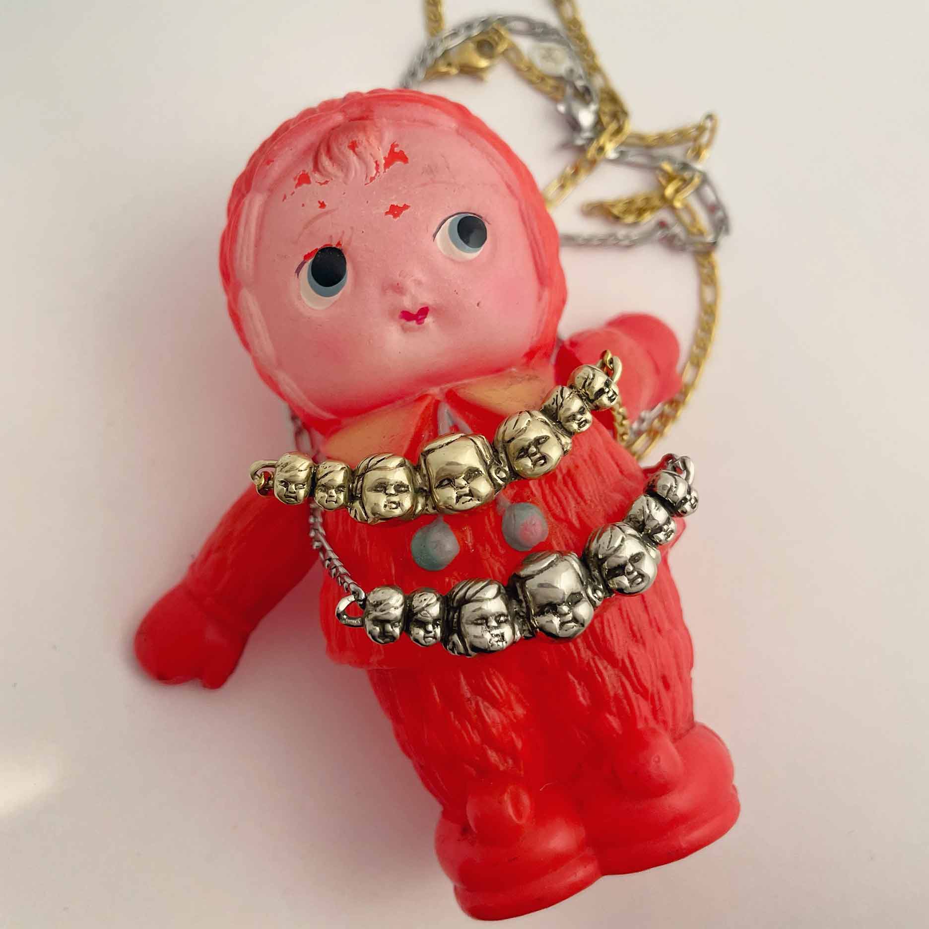 comparison silver and gold necklaces 7 baby doll heads creepy cute unique peculiar jewelry