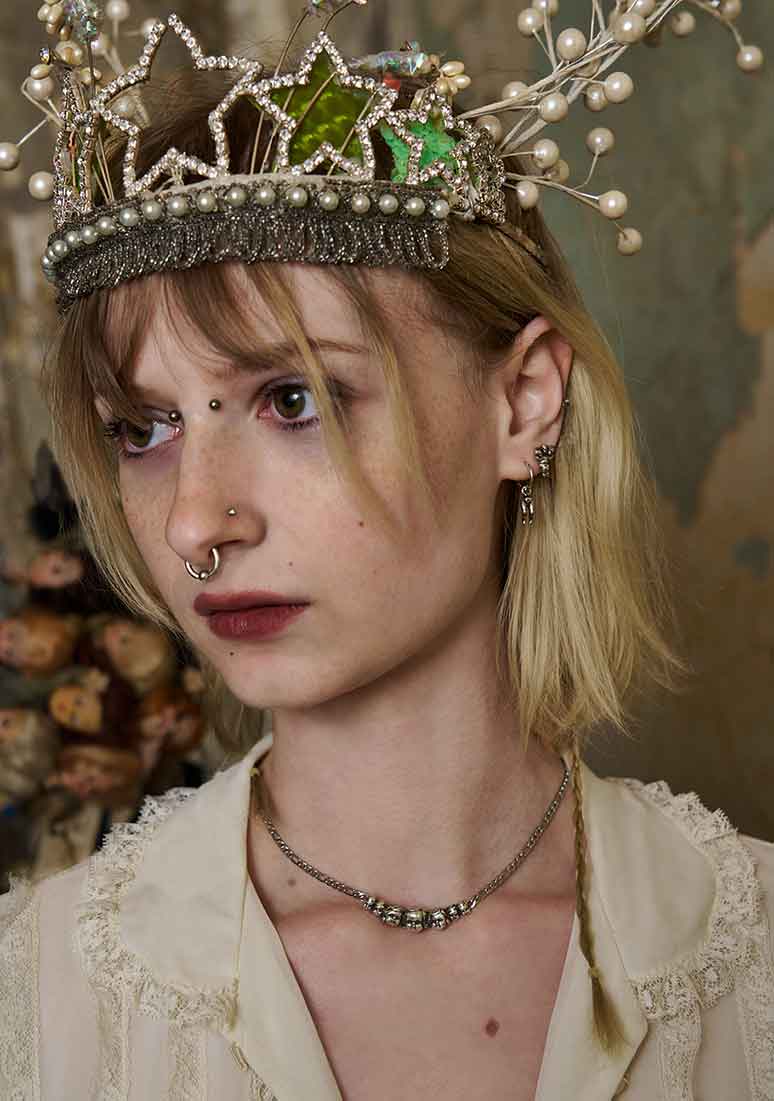 model wearing baby doll head necklace silver minimal unique handmade