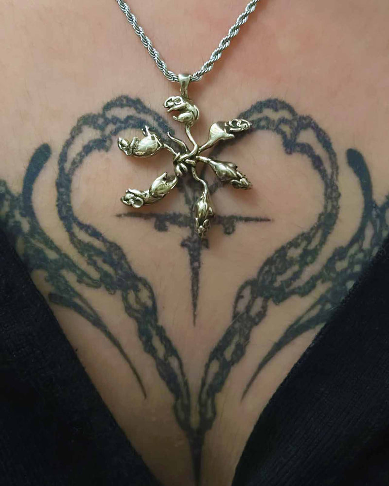 rat king necklace on a tattooed neck