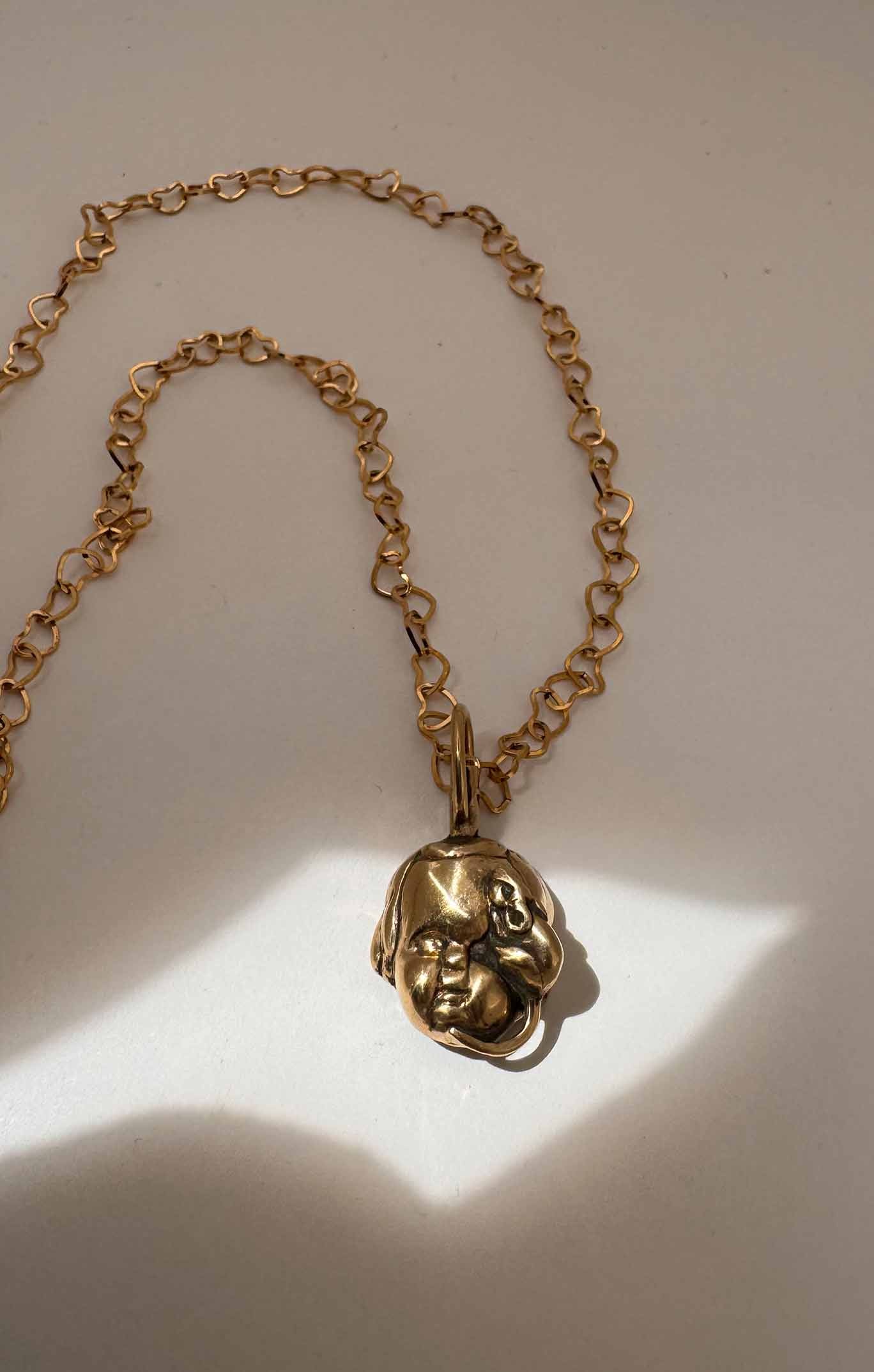 Baby Eating a Rat Necklace