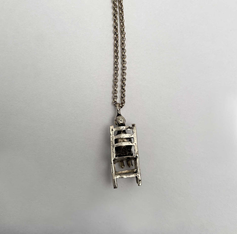 back of sitting duck in a chair necklace charm silver
