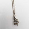 side view sitting duck in a chair necklace charm