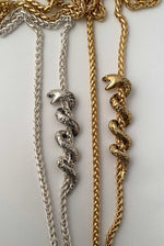 silver and gold serpent snake coiled around chain necklace 